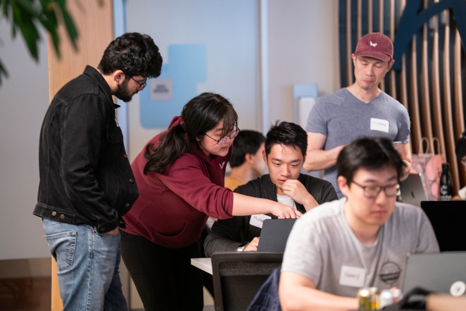 Builders collaborating around a laptop